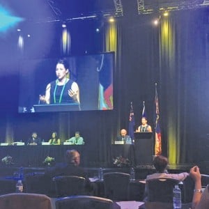 young woman making a presentation at a conference