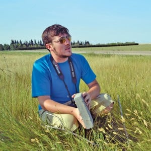 man sitting in field