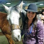 young woman with horse at rodeo