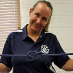 woman tying a knot in a rope