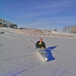 man in kayak sliding on snow