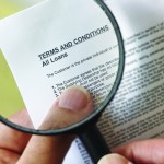 Magnifying glass looking over a contract.