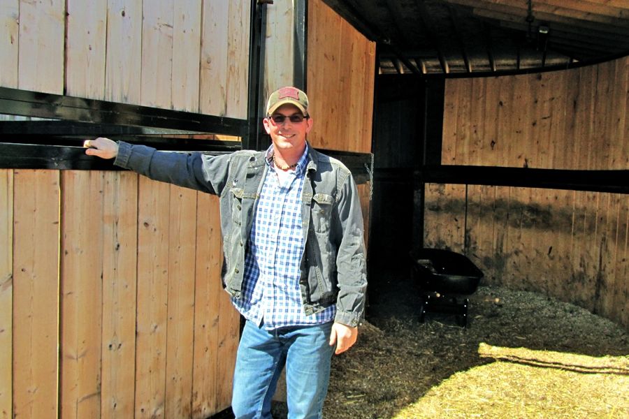 man standing in barn