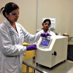 Research scientist Harmadeep Kaur demonstrates part of microwave extraction at Radient Technologies.