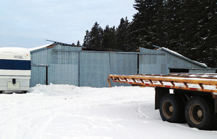 This central Alberta machine shed looked OK from the front, but had actually collapsed under heavy snow this winter (see below). Whether replacing or building new, experts say an engineered structure is worth the investment.