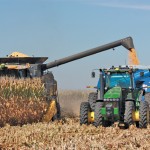 combine dumping corn into a driverless tractor