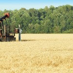 oil derrick in a wheat field