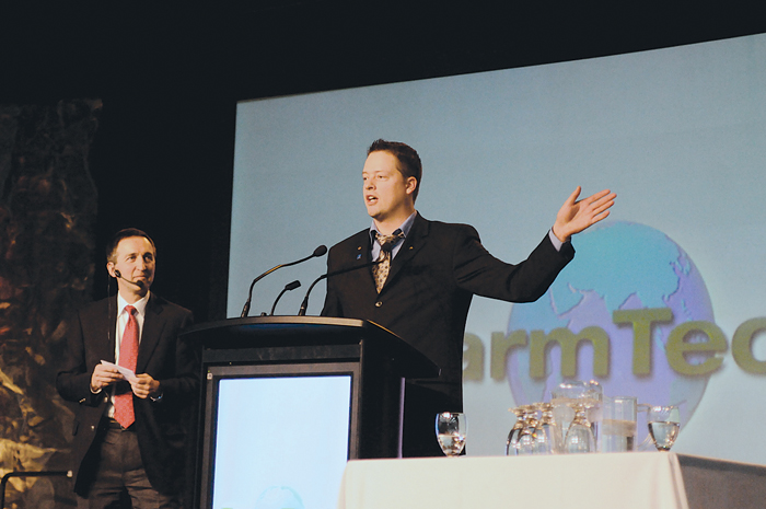 man on stage at conference