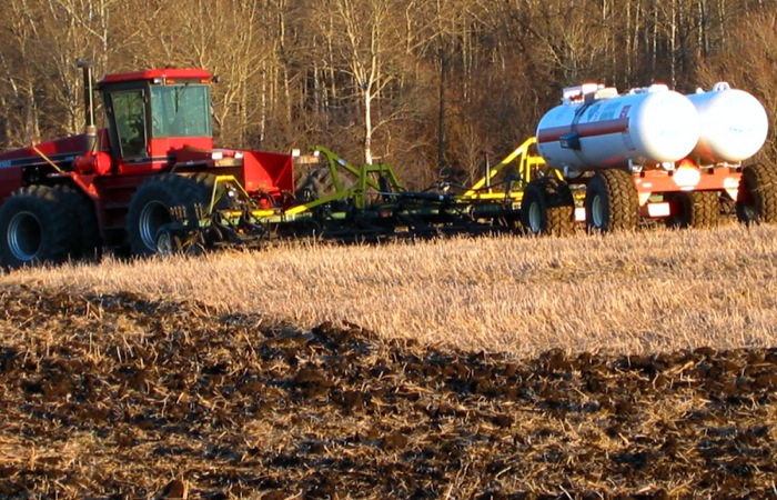farm machinery fertilizing a field