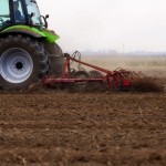 tractor tilling a field