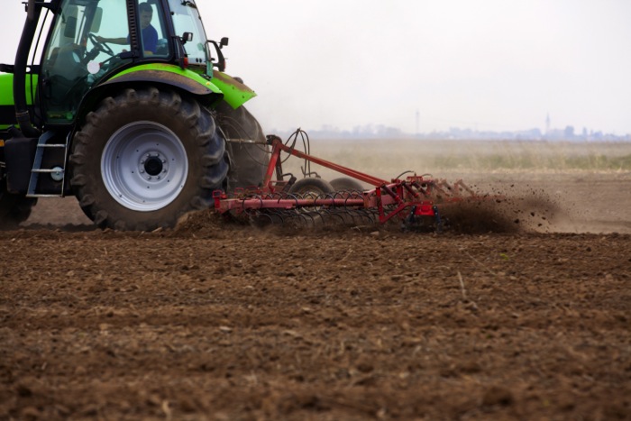 tractor tilling a field
