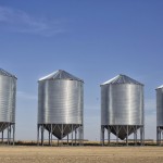 grain bins in a farmer's field