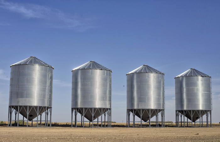grain bins in a farmer's field