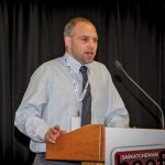 man speaking at podium