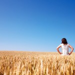 woman standing in a field of wheat