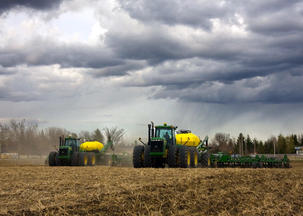 tractors seeding a field