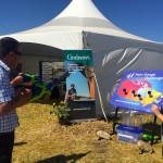 Two Saskatchewan farmers take up the rain gauge challenge with water pistols at the CocoRaHs water gun booth.