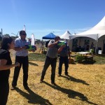 Two Saskatchewan farmers take up the rain gauge challenge with water pistols at the CocoRaHs water gun booth.