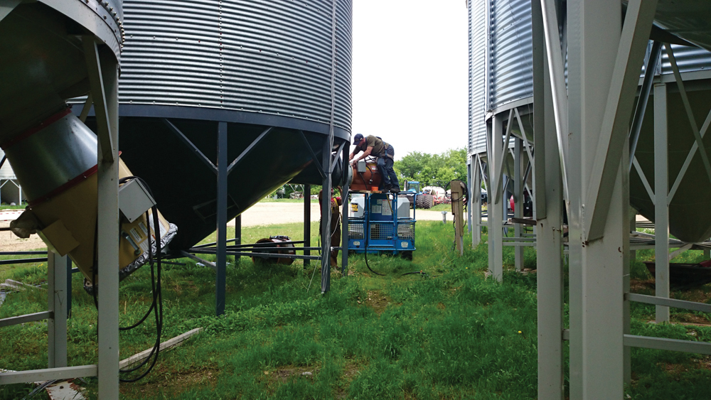 Installation of a fan on a 4,000-bushel hopper bin.