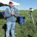 Thomas Flesch, a meteorologist from the University of Alberta, stands next to an open sensor used to collect methane emissions from cattle, at the Lacombe research station.