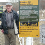 Gottlob Schmidt stands by the sign installed at the gate to his property. The 90-year-old Schmidt donated his farm to the province and it will become Alberta’s 76th provincial park.
