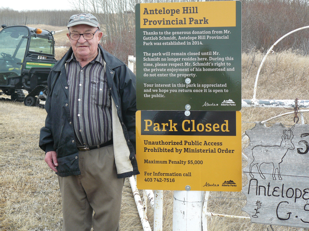 Gottlob Schmidt stands by the sign installed at the gate to his property. The 90-year-old Schmidt donated his farm to the province and it will become Alberta’s 76th provincial park.