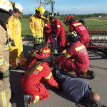 In this training simulation, emergency responders first cut open a portion of a grain auger to assess how badly the ‘victim’ is injured and then cut the auger to free its leg.