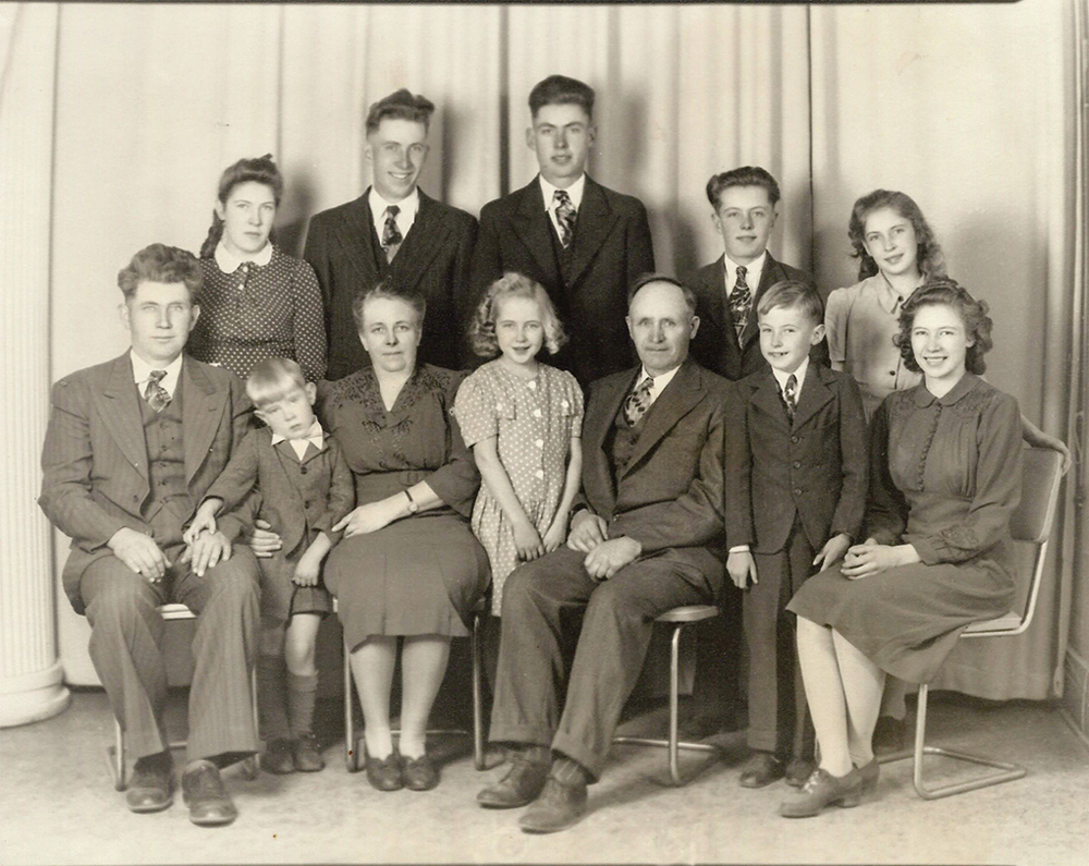 C.C. (left) and Anna Toews, with their children and ‘Uncle Corny.’ In front (left to right) Gerry, Eleanor, Allen, and Erma. In the rear, Gladys, Henry, Fred, Wes, and Ruth.