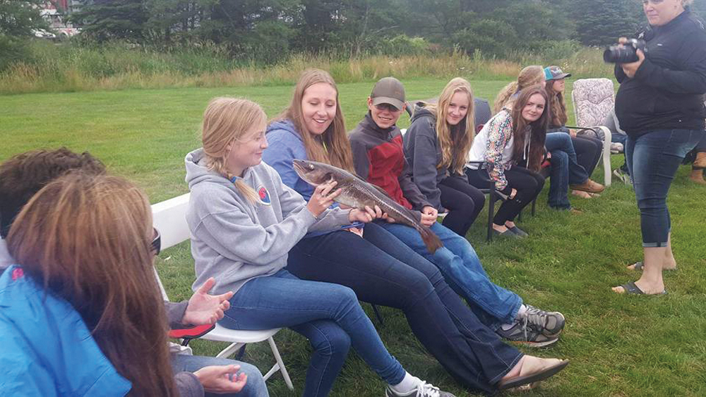 Yes b’y, that’s a real live cod that Brooke Hammond was working up the courage to kiss when she and her fellow 4-H’ers were ‘screeched in’ upon their arrival in Newfoundland.