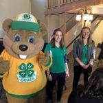 4-H members Chelsea Carroll (left) and Christine Suominen joined Cleaver the Beaver at the Southern Region’s centennial kickoff in September.