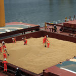 There’s a worldwide glut of most major grains, but analysts are optimistic that Prairie farmers will see some price improvement this year. This photo shows workers loading soybeans in March for export to China.