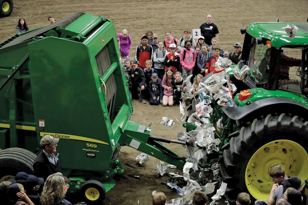 As the power take-off shaft catches hold of the dummy's clothing, the motion rips the dummy apart, sending newspaper flying into the air.