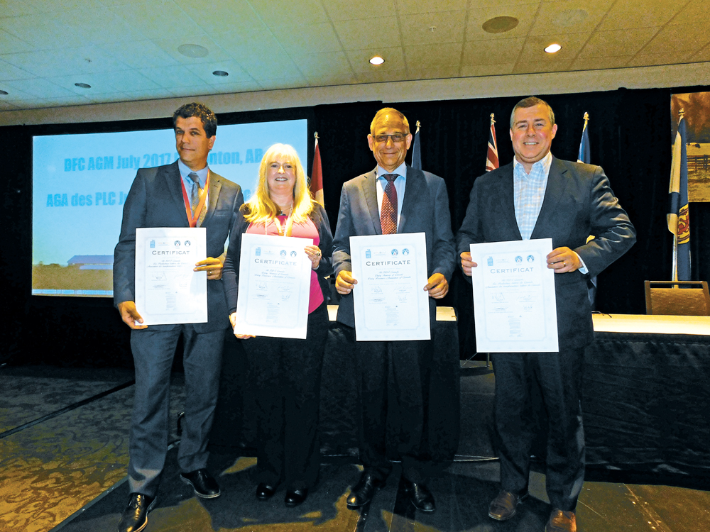 Parmalat Canada senior vice-president Gilles Froment, (l to r) Dairy UK chief executive Judith Bryans, outgoing Dairy Farmers of Canada president Wally Smith, and Dairy Processors of Canada president and CEO Jacques Lefebvre show off copies of the Rotterdam Declaration.