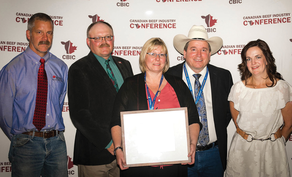 Karen Schwartzkopf-Genswein was presented with her outstanding researcher award at the recent Canadian Beef Industry Conference by (left to right) Beef Cattle Research Council science director Reynold Bergen, council vice-chair Matt Bowman, Ken Perlich of Perlich Bros. Auction Market, and research council executive director Andrea Brocklebank.