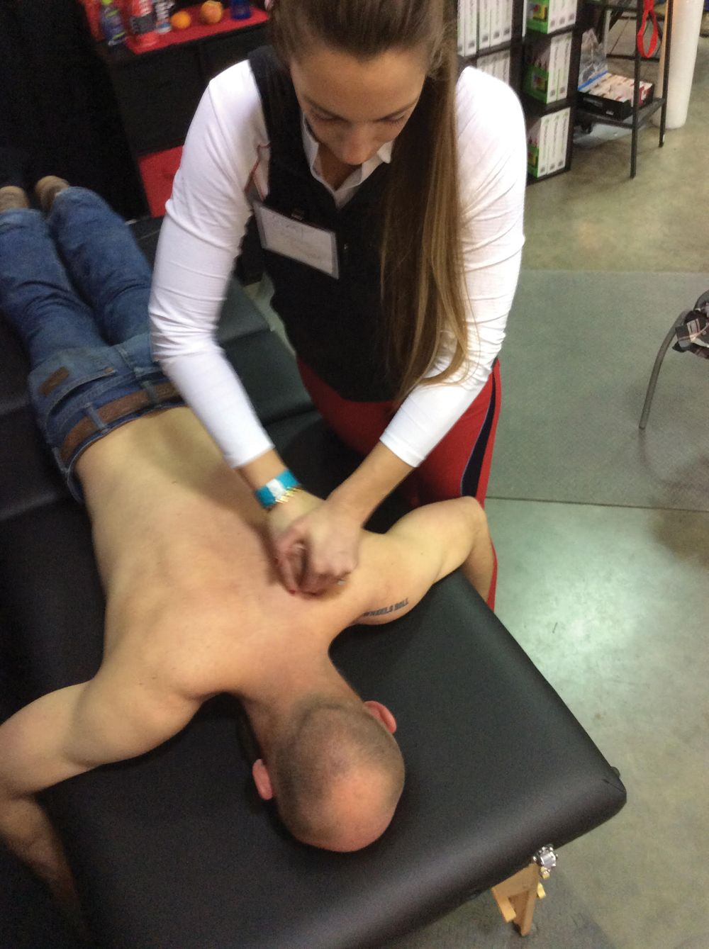 Keira Forsyth performs physiotherapy on a client with a rotator cuff injury.