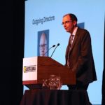 New chair Renn Breitkreuz addresses the annual general meeting of the Alberta Canola Producers Commission at FarmTech. The Onoway producer succeeds Greg Sears (shown on the screen in background) while Westlock grower John Guelly steps into vice-chair role. The organization also welcomed two new directors: Andre Harpe of Valhalla Centre replaces Sears in Region 2, while Airdrie producer Ian Chitwood succeeds Steve Marshman in Region 8.