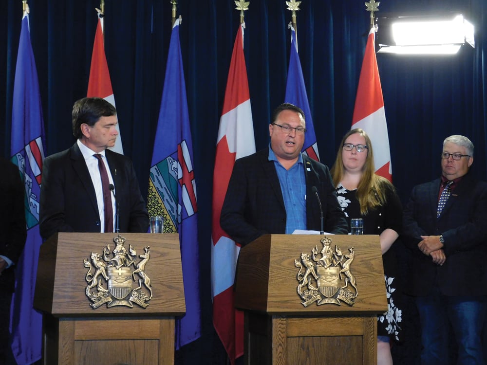 Too much progress has been made on workplace safety rules to go back to square one, says AgCoalition chair Albert Kamps, seen here at a news conference with Labour Minister Christina Gray.