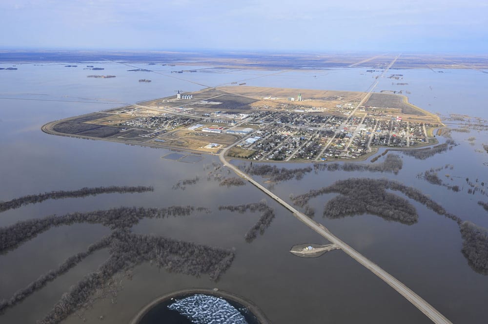 Seven years ago, flooding caused more than $1 billion in damages in Manitoba. Shown is a 2011 photo of the southern Manitoba town of Morris, which is protected by a ring dike.