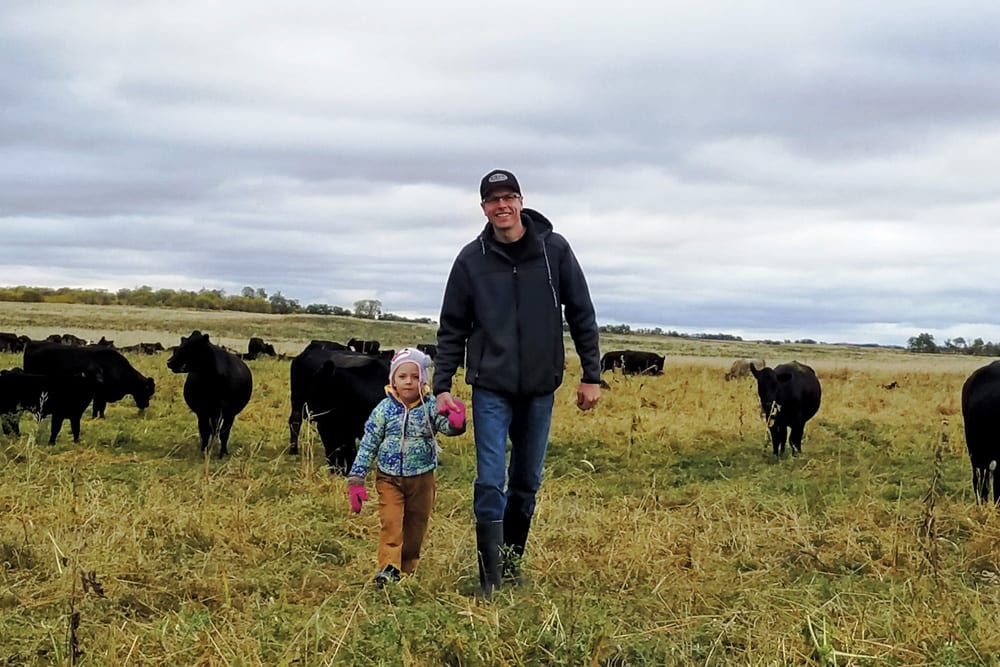 Getting more out of fewer acres while lowering risk prompted Ryan Boyd, pictured with daughter Piper,  to try regenerative agriculture.