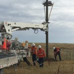 A team puts the finishing touches on the new nesting platform and nest for the ferruginous hawks.