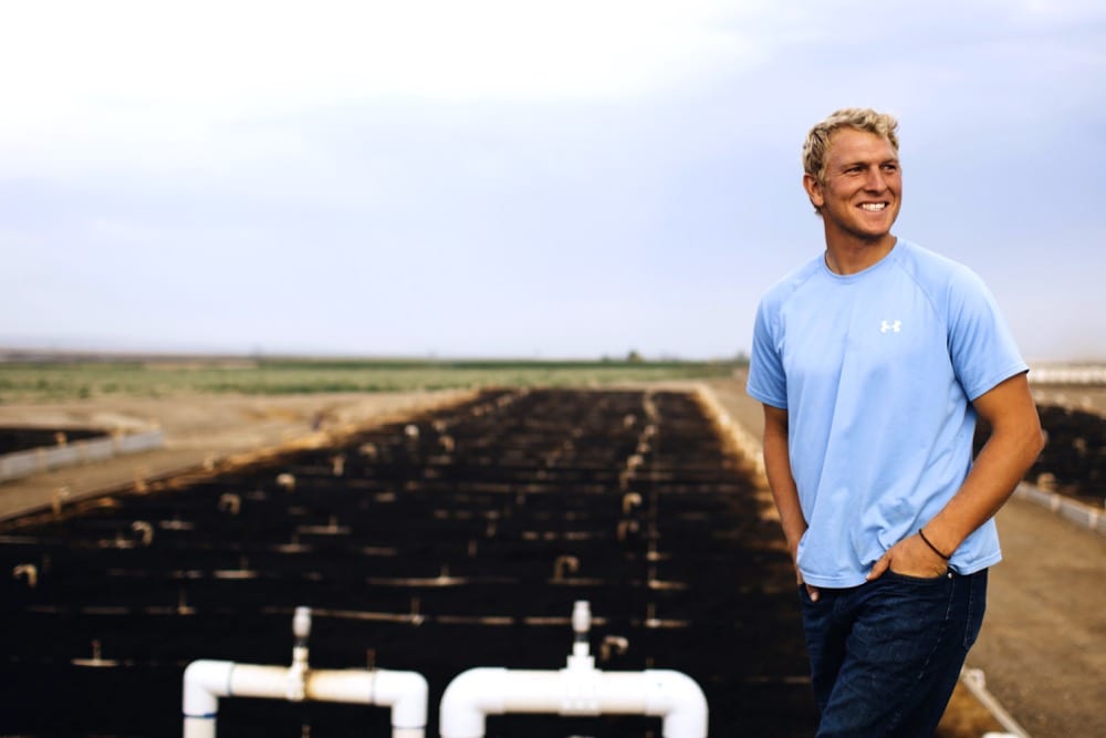 Austin Allred stands in front of the BioFiltro system installed on his 5,000-cow dairy in Washington state. The system, the first in North America, treats waste water in a matter of hours. 
