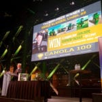 Rob Saik announcing Merle Klassen as winner of the Canola 100 at Farm Forum on Dec. 5.