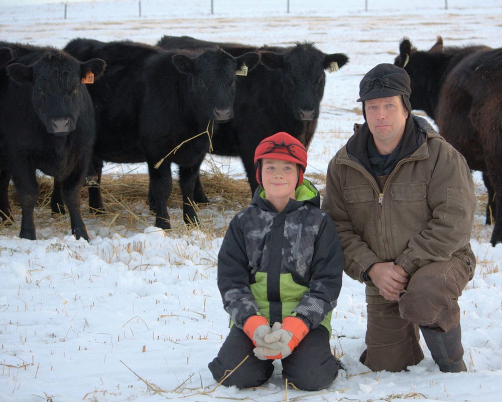 Working with a vet allows you to be both proactive about herd health and have an exact plan to deal with common problems, such as foot rot or calf pneumonia, says Ian Murray, pictured with son Ty at his Acme-area ranch.
