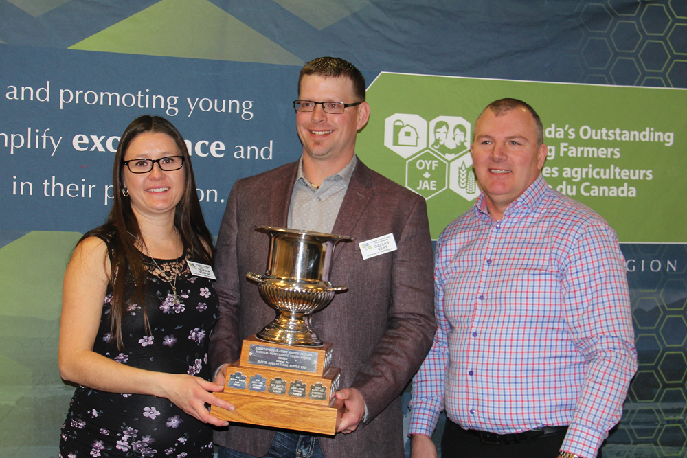 Natasha Pospisil and Dallas Vert, alongside judge Tom Terrill of CIBC, are this year’s  Alberta Outstanding Young Farmers.