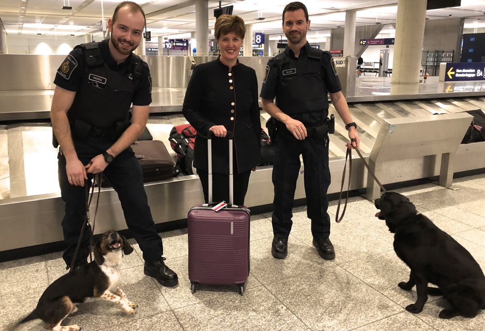 Agriculture Minister Marie-Claude Bibeau, shown here March 14, 2019 at the Montreal-Trudeau airport with Canadian border services officers and detector dogs, announced new funding to expand Canada’s detector dog corps. (CNW Group/CFIA)
