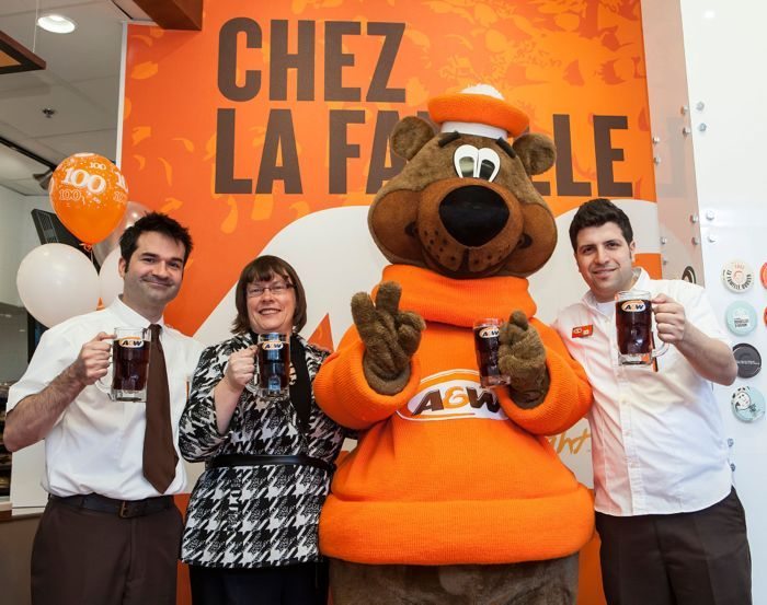 A+W — whose Root Bear mascot is shown here in March 2013, opening the chain’s 100th restaurant in Quebec — booked higher same-store sales in 2013, partly crediting its “Better Beef” campaign. (CNW Group/A+W Food Services of Canada Inc. )
