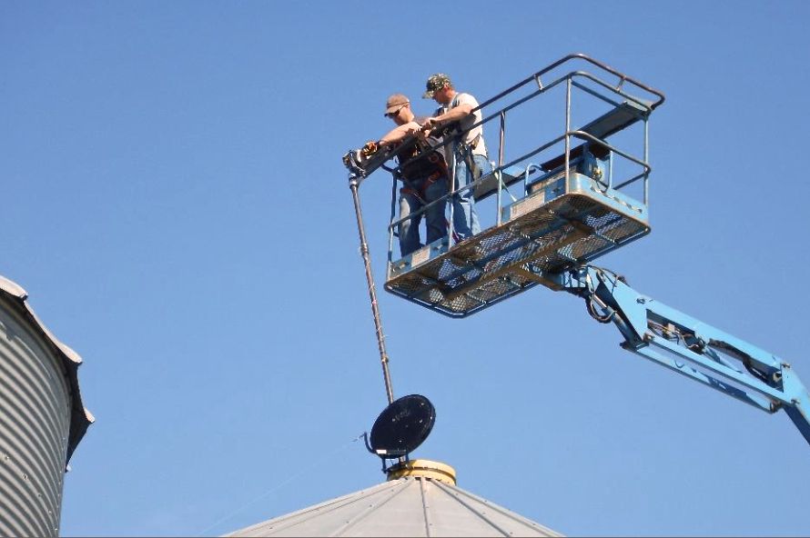 PAMI researchers install a probe in a canola bin as part of a temperature monitoring study, which ran from June through to mid-August 2016. (PAMI.ca)
