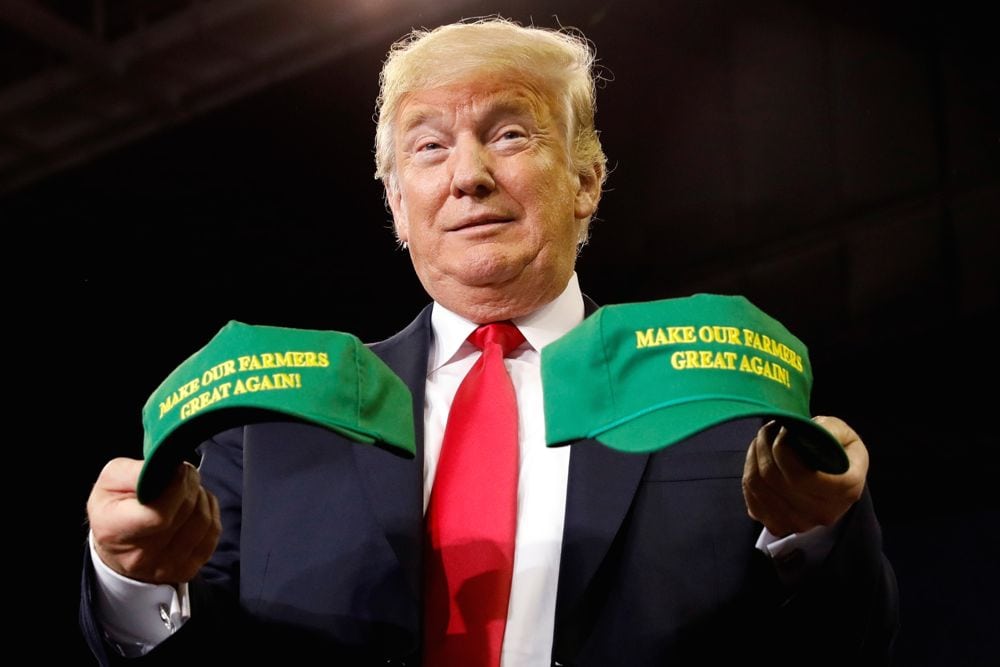 U.S. President Donald Trump holds “Make Our Farmers Great Again” hats during a “Make America Great Again” rally in Evansville, Indiana on Aug. 30, 2018. (Photo: Reuters/Kevin Lamarque)
