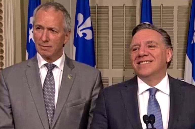 Andre Lamontagne, shown here at left at a press conference in May 2017 with CAQ leader Francois Legault, is Quebec’s new agriculture minister. (Video screengrab from AssNat.qc.ca)
