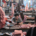 Pork accounts for nearly two-thirds of China’s meat consumption and with African swine fever decimating Chinese production, Canada’s pork sector had hoped to see its exports to China jump rather than be banned. Pictured here are pork vendors at a market in Yunnan province in May.